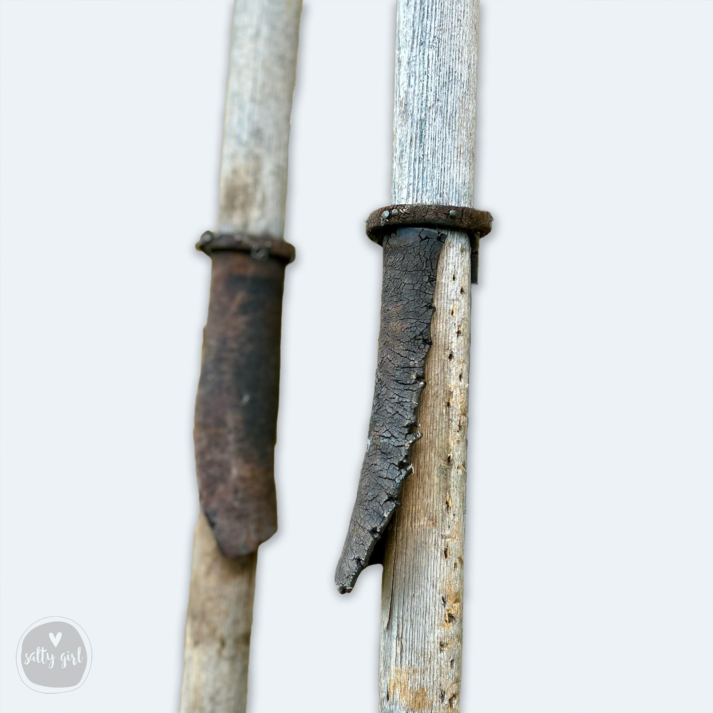 a close up of two knives with a white background