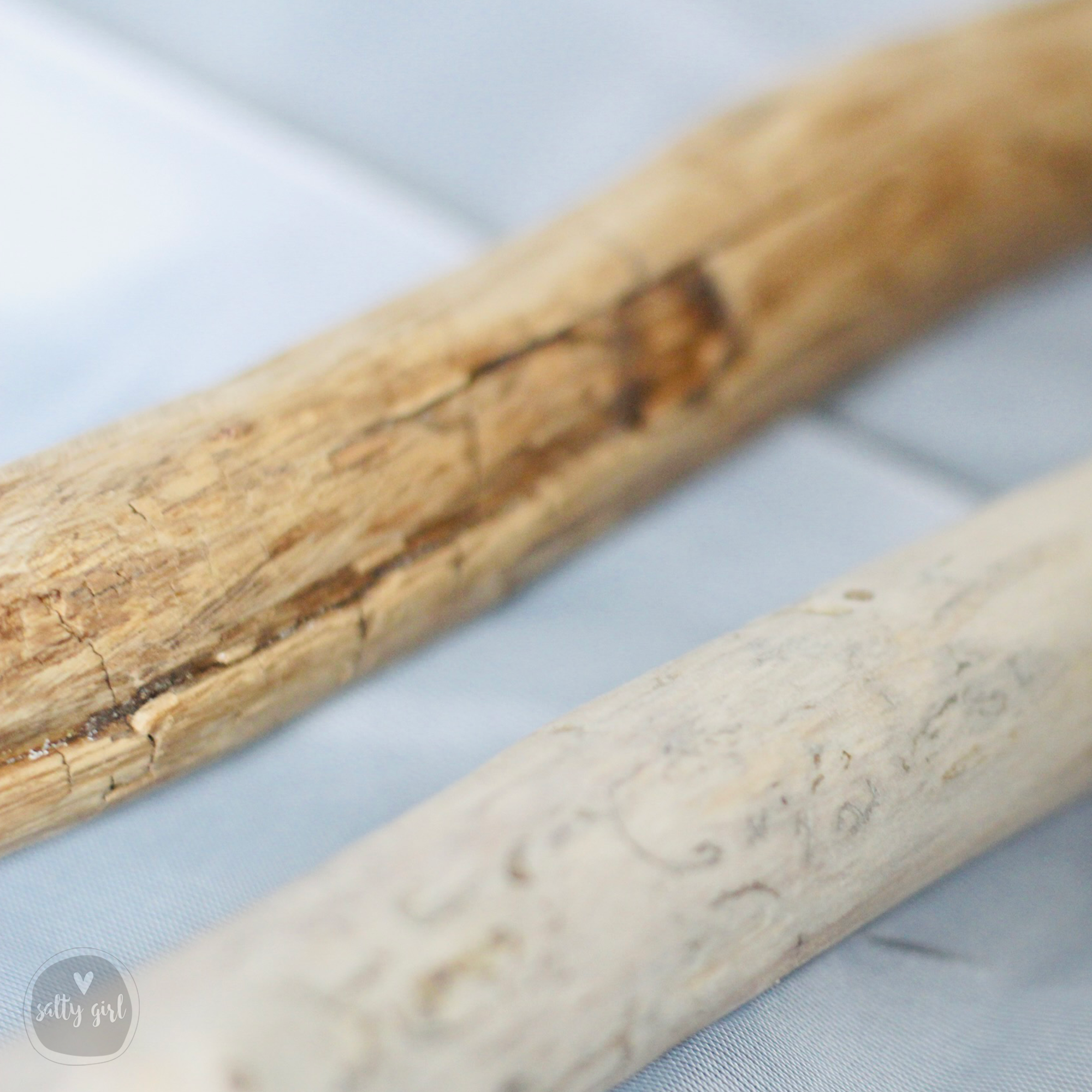 Two wooden sticks are placed next to each other on a surface.