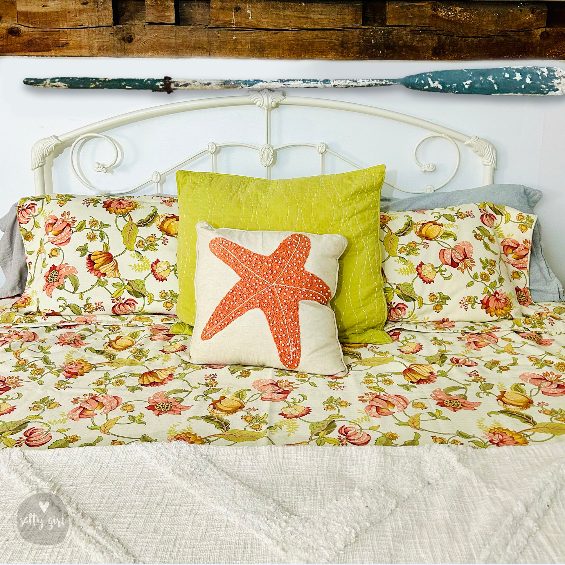 a white bed topped with pillows and a starfish