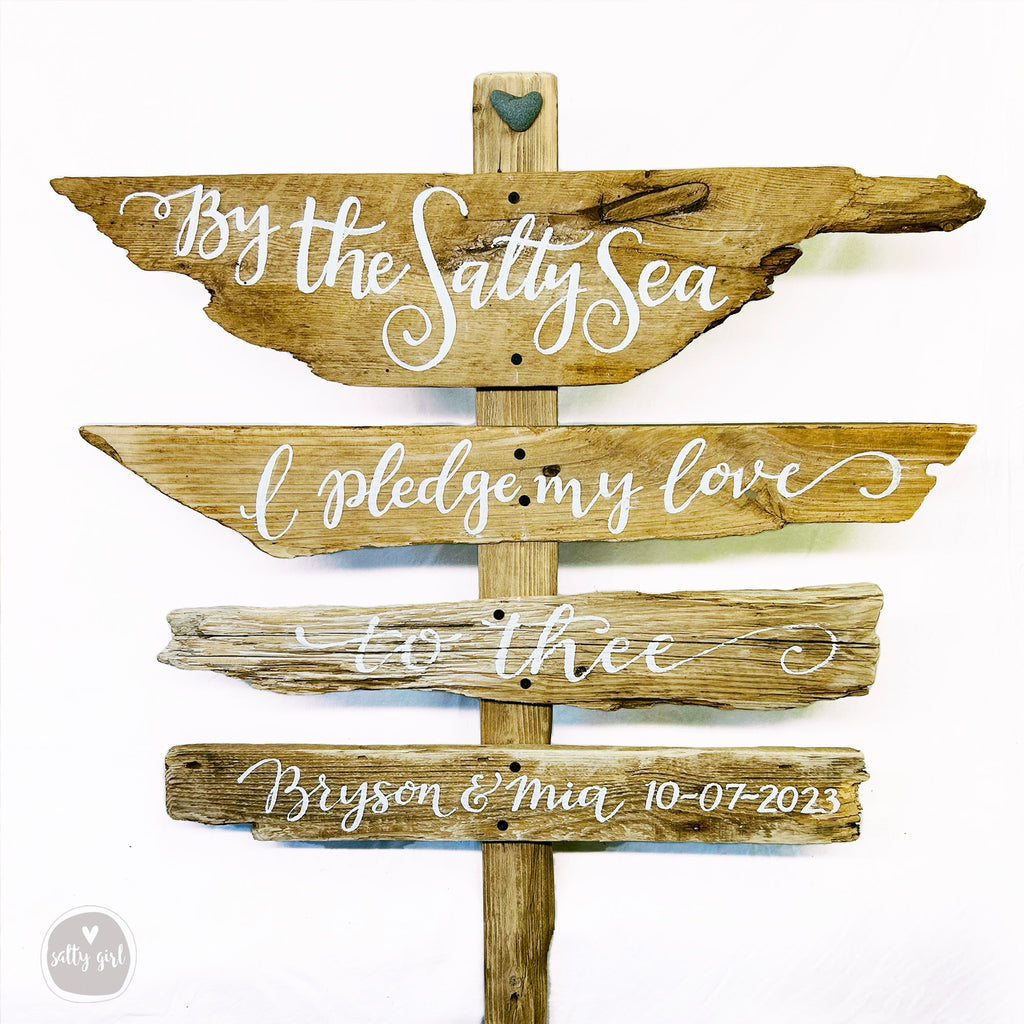 A wooden sign with a heart-shaped decoration, displaying a message about love and commitment.