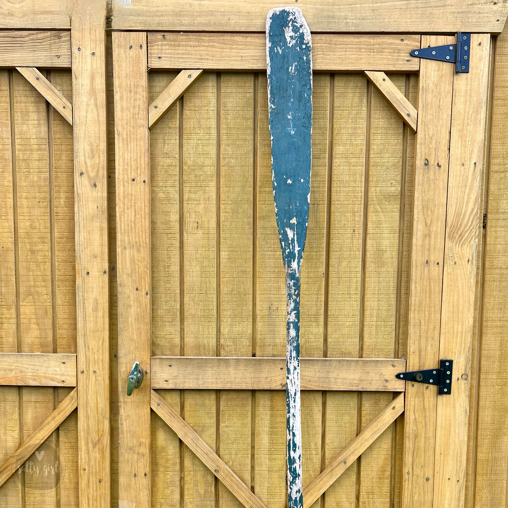 a baseball bat leaning against a wooden fence