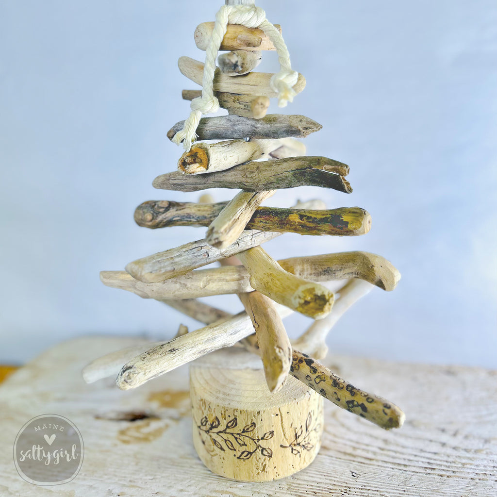 A creative arrangement of driftwood branches and twigs, forming a unique and rustic Christmas tree-like structure.