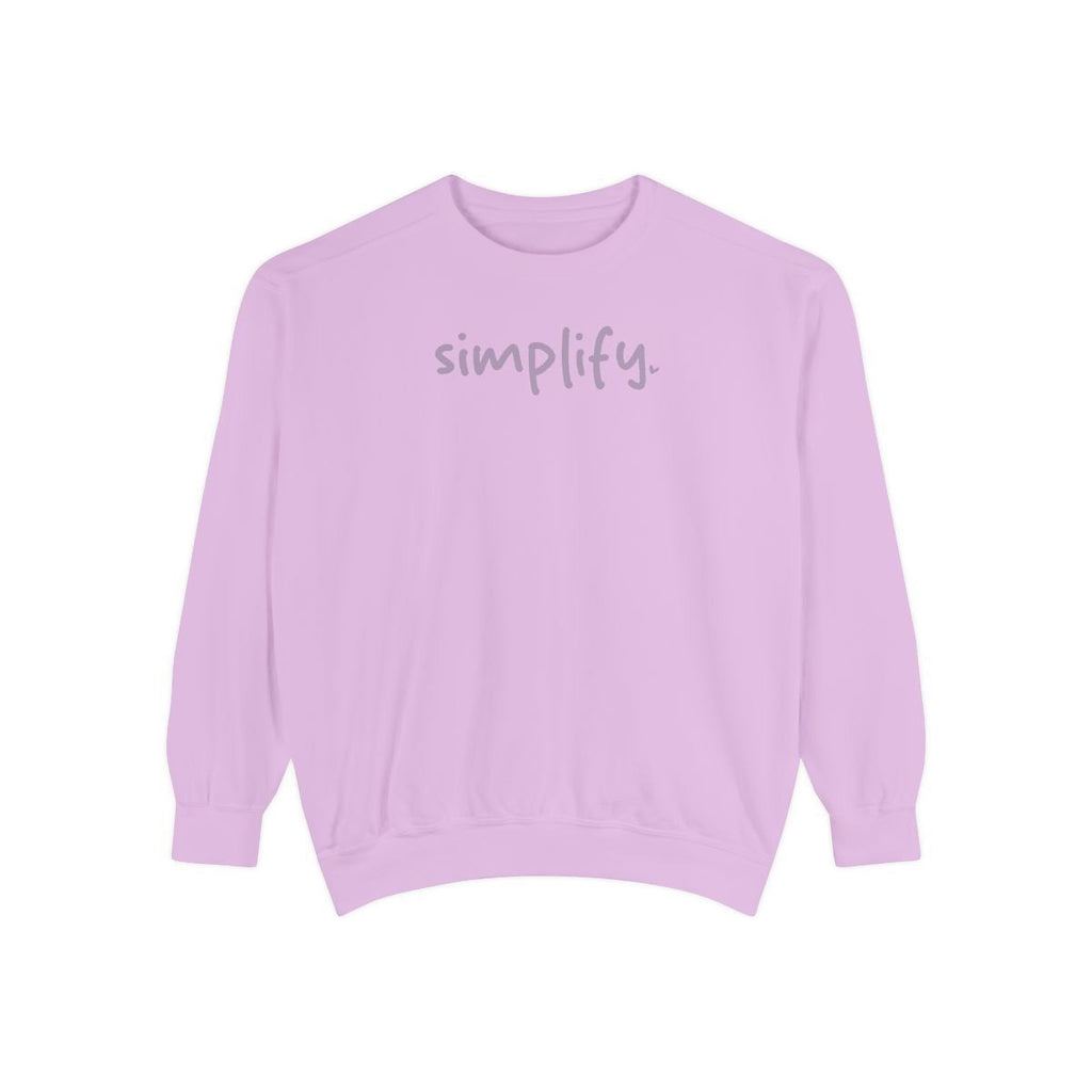 A pink sweatshirt with the word "simplify" printed on it.