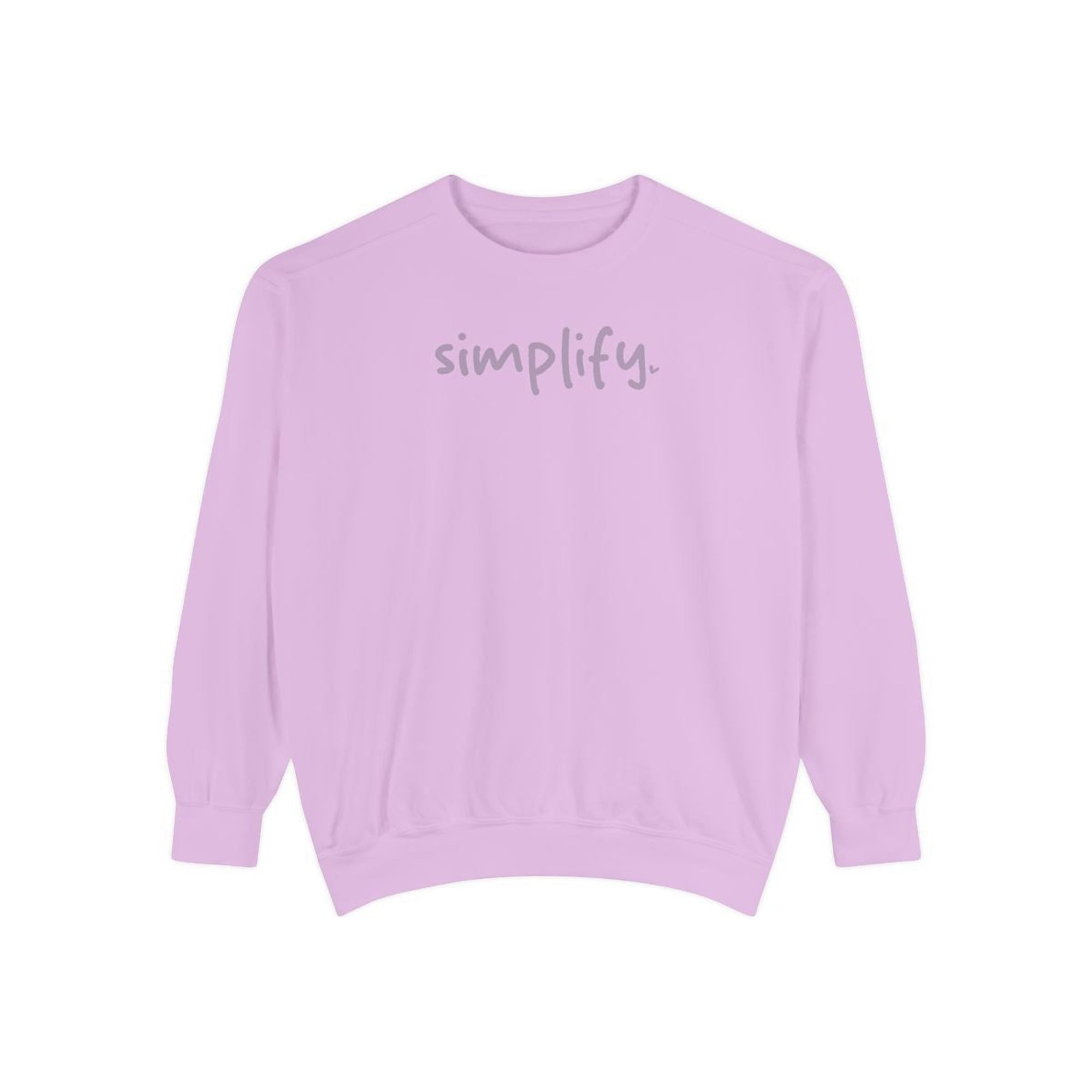 A pink sweatshirt with the word "simplify" printed on it.