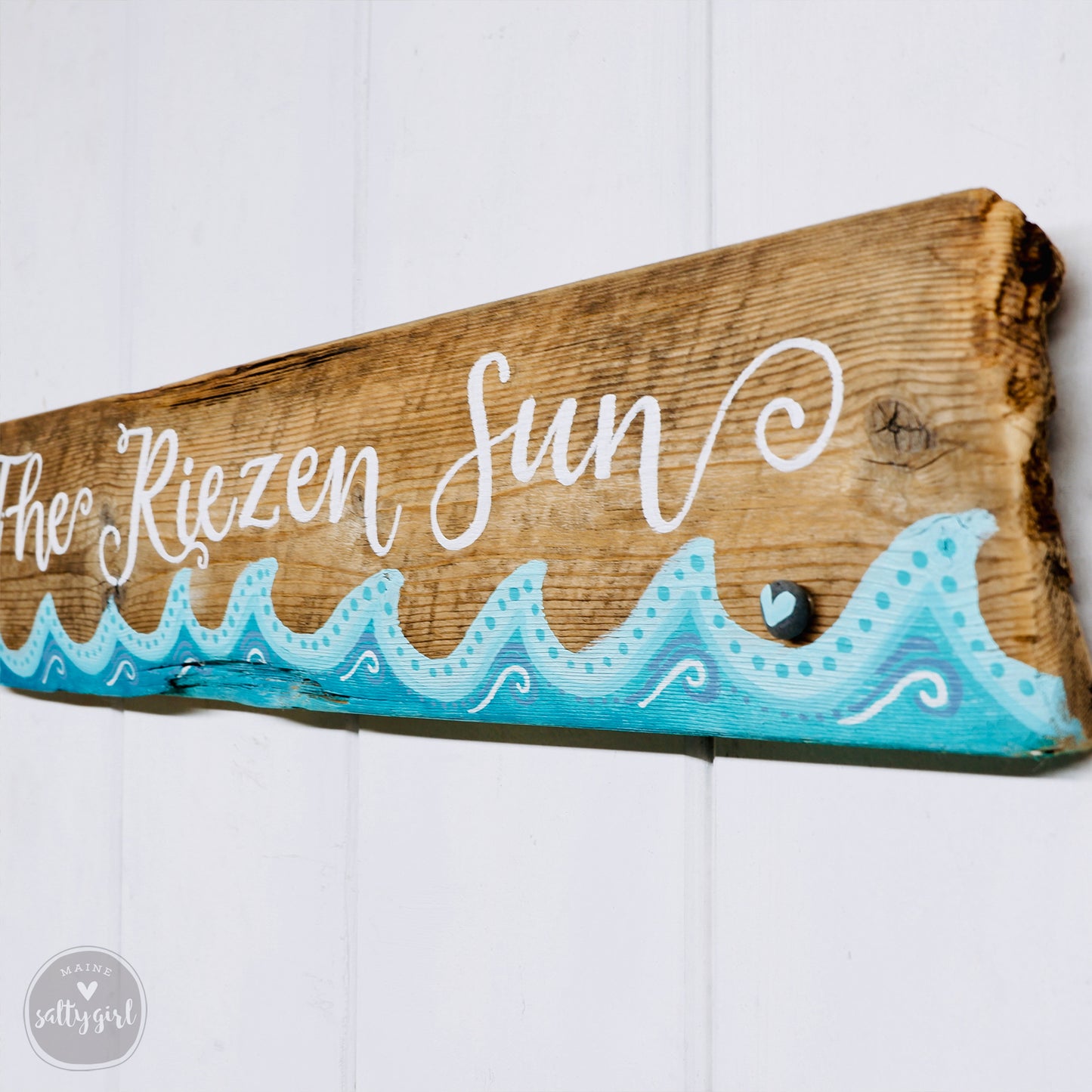 a wooden sign that says the frozen sun on it