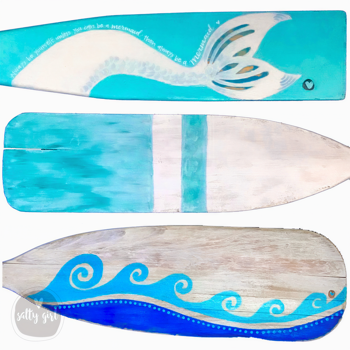 three wooden oars with different designs painted on them. The oars are arranged in a row, showcasing their unique and creative artwork.