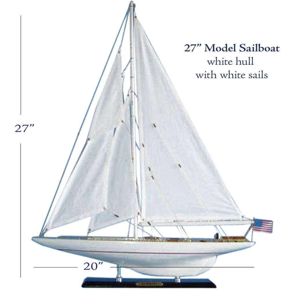 A model sailboat with white hull and white sails, measuring 27 inches in length and 20 inches in width.