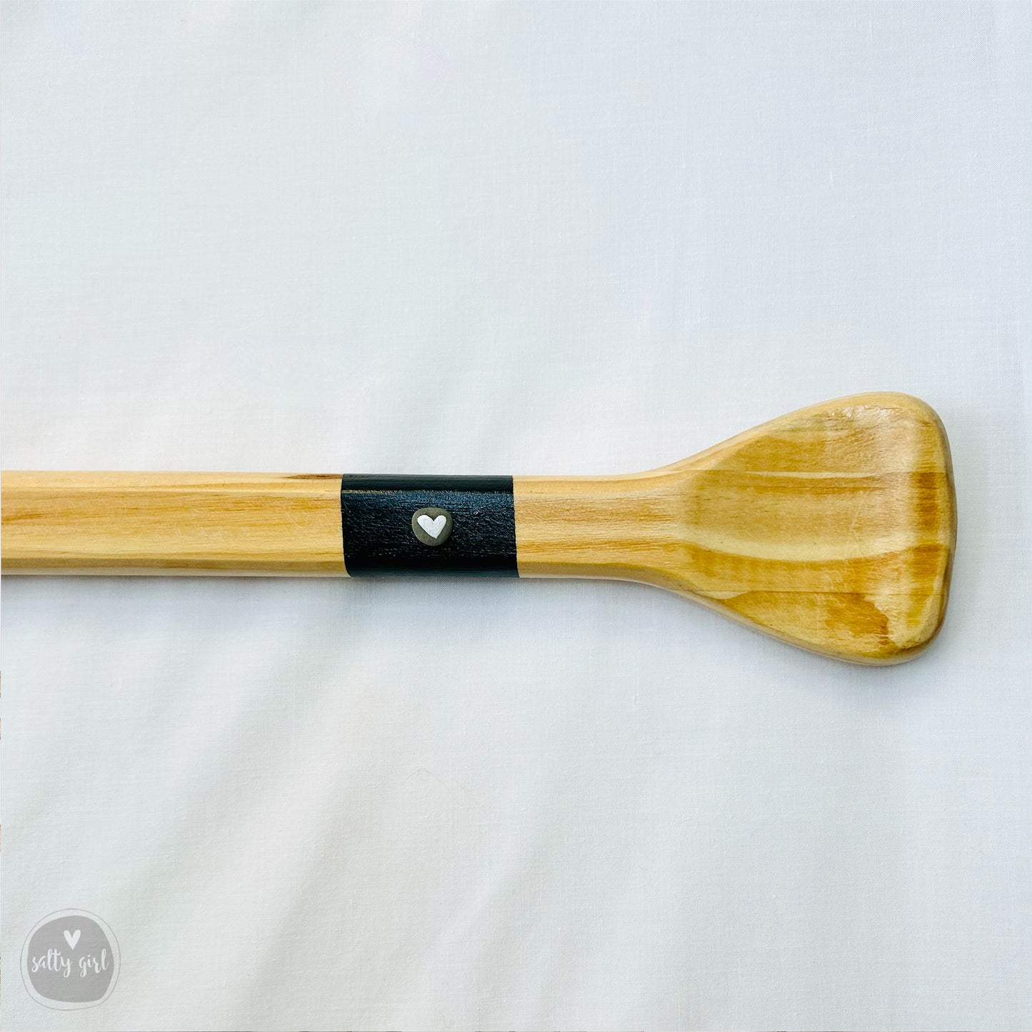 a close up of a wooden paddle on a white background