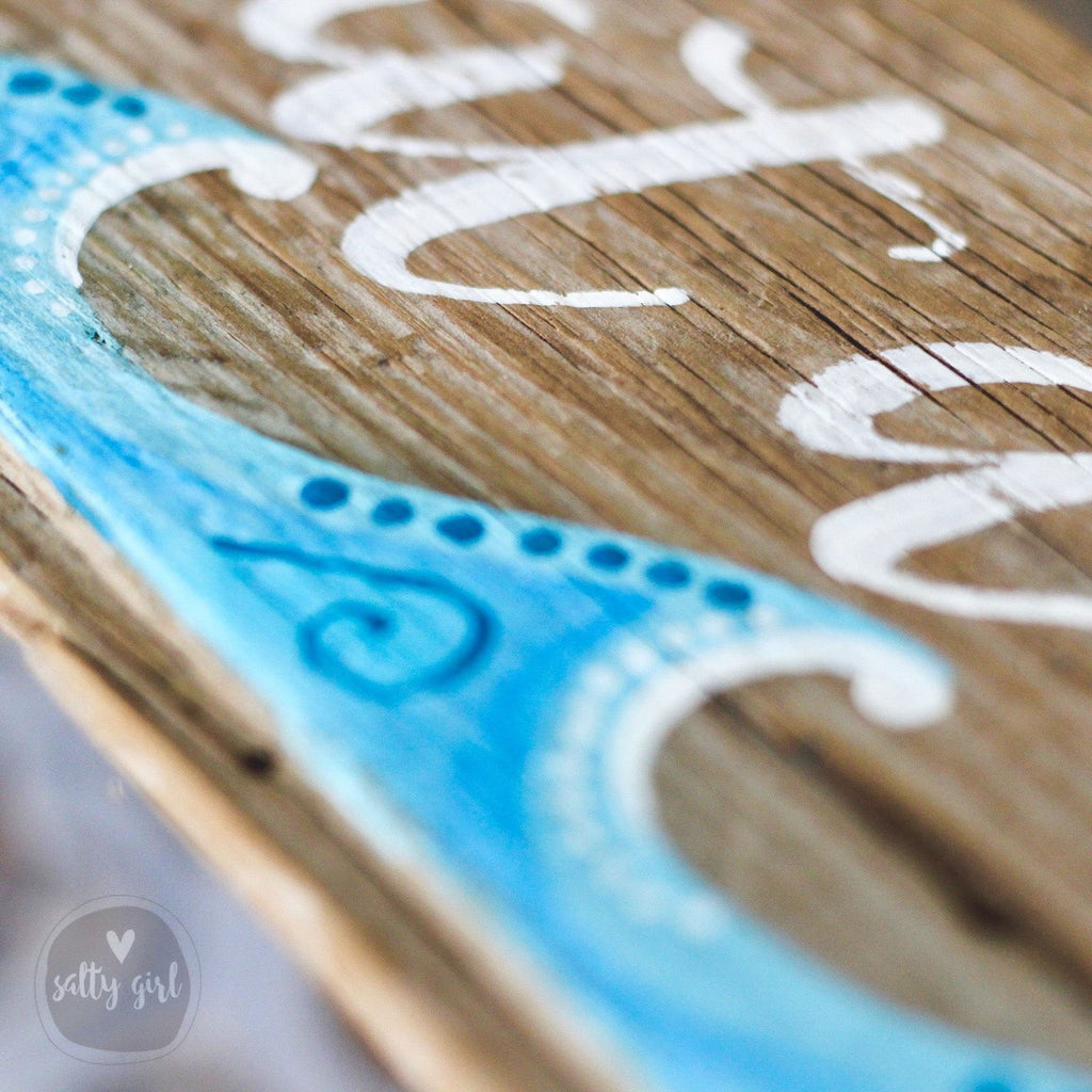 a close-up view of a wooden surface with a painted design resembling a wave or a wave-like pattern.