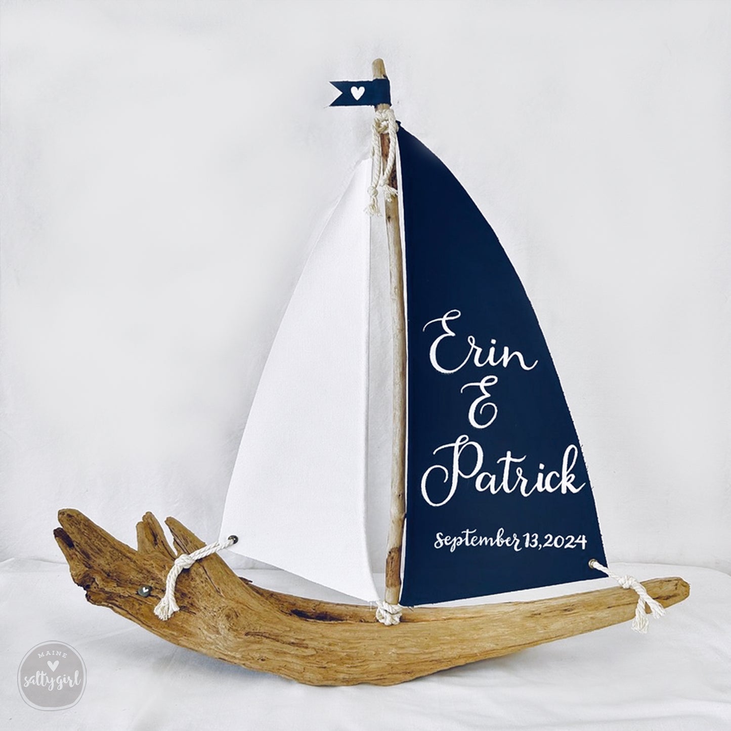 a wooden sailboat with a sign on it