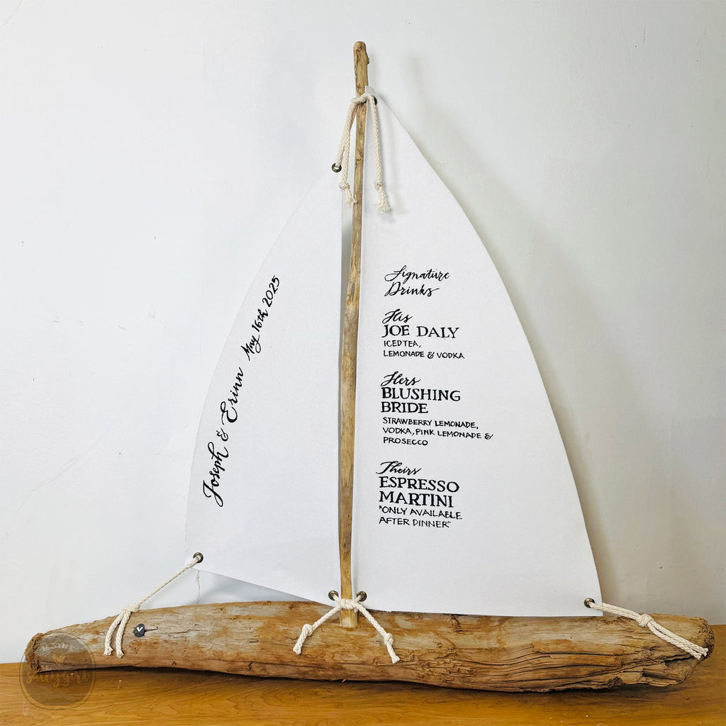 a sailboat made out of driftwood on a table
