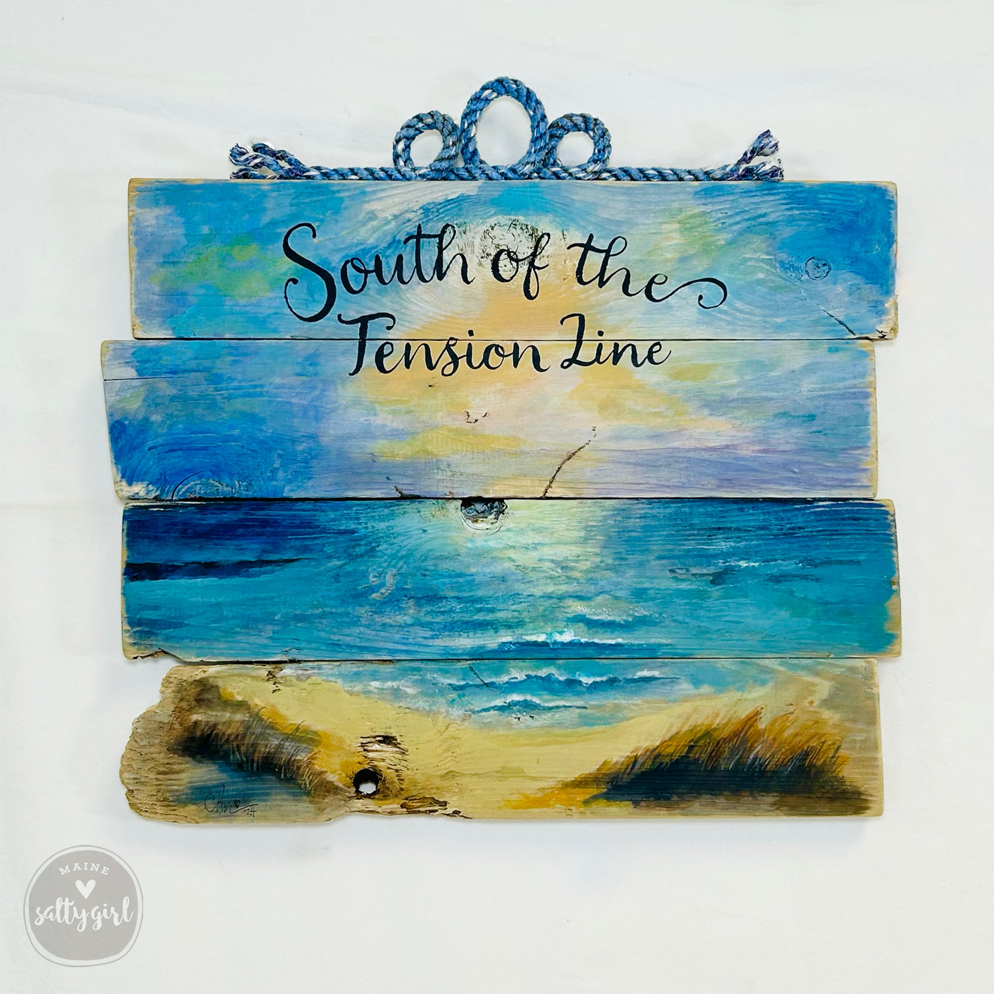 a wooden sign that says south of the tension line