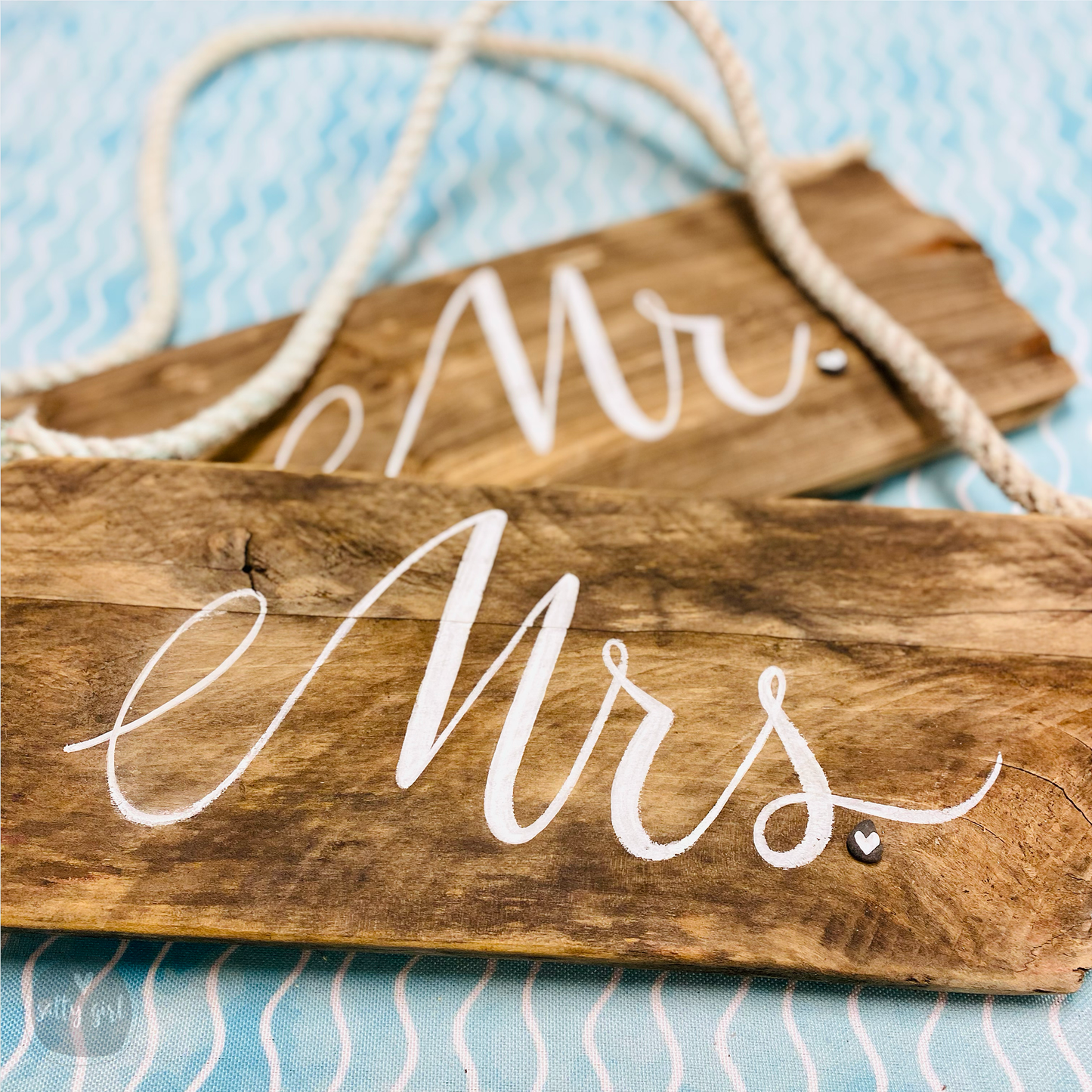 a couple of wooden signs sitting on top of a table