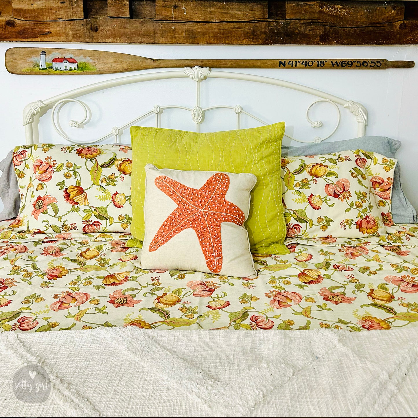 a bed with a white headboard and a starfish pillow