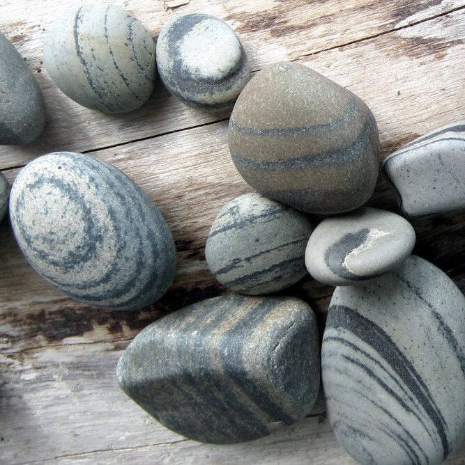 Striped beach stones on driftwood board