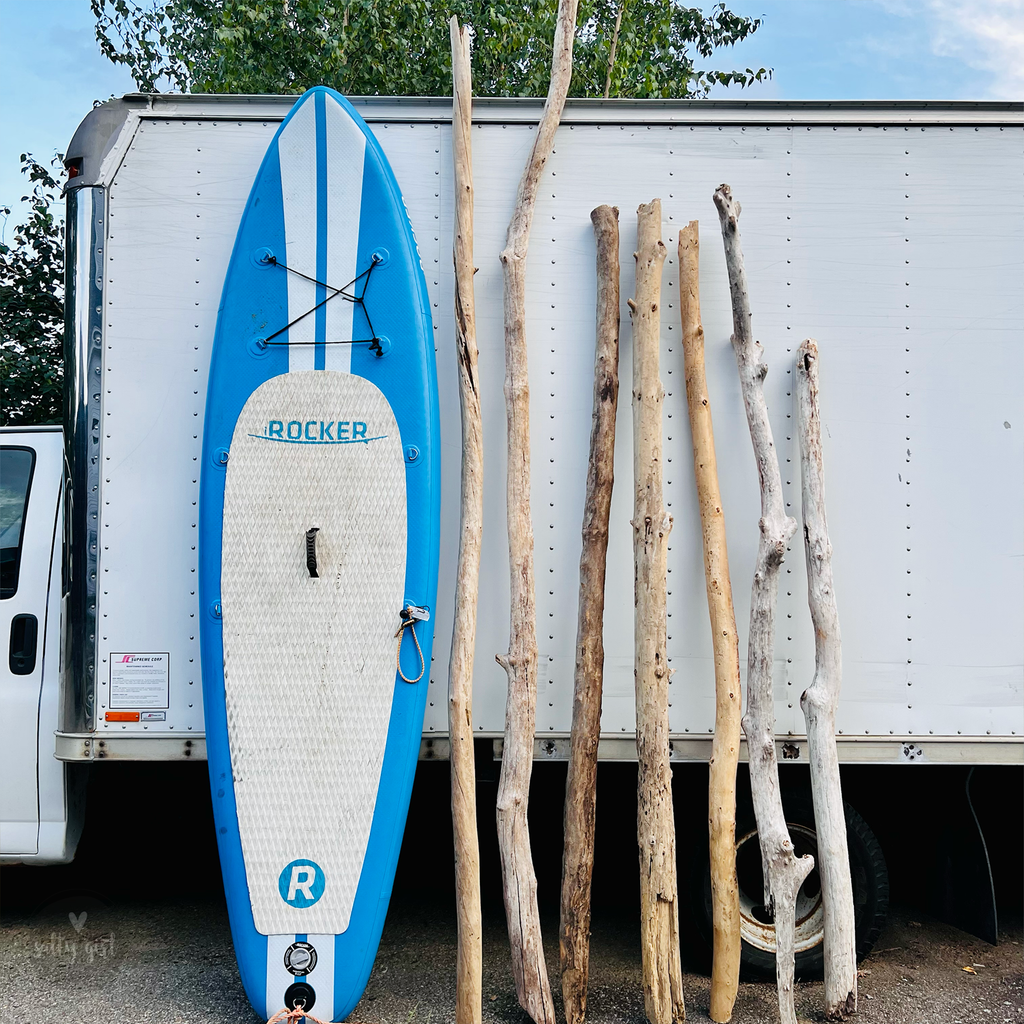 Driftwood handrail pieces next to paddleboard
