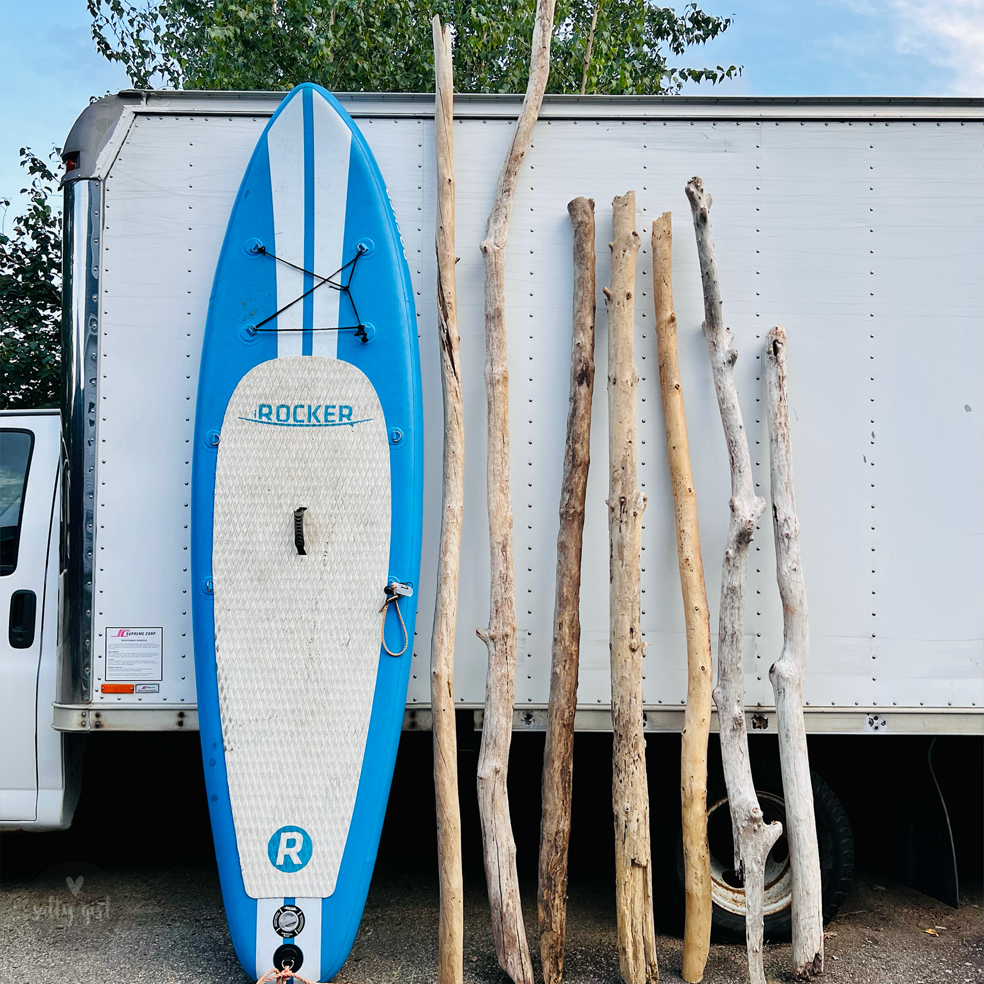 Driftwood handrail pieces next to paddleboard
