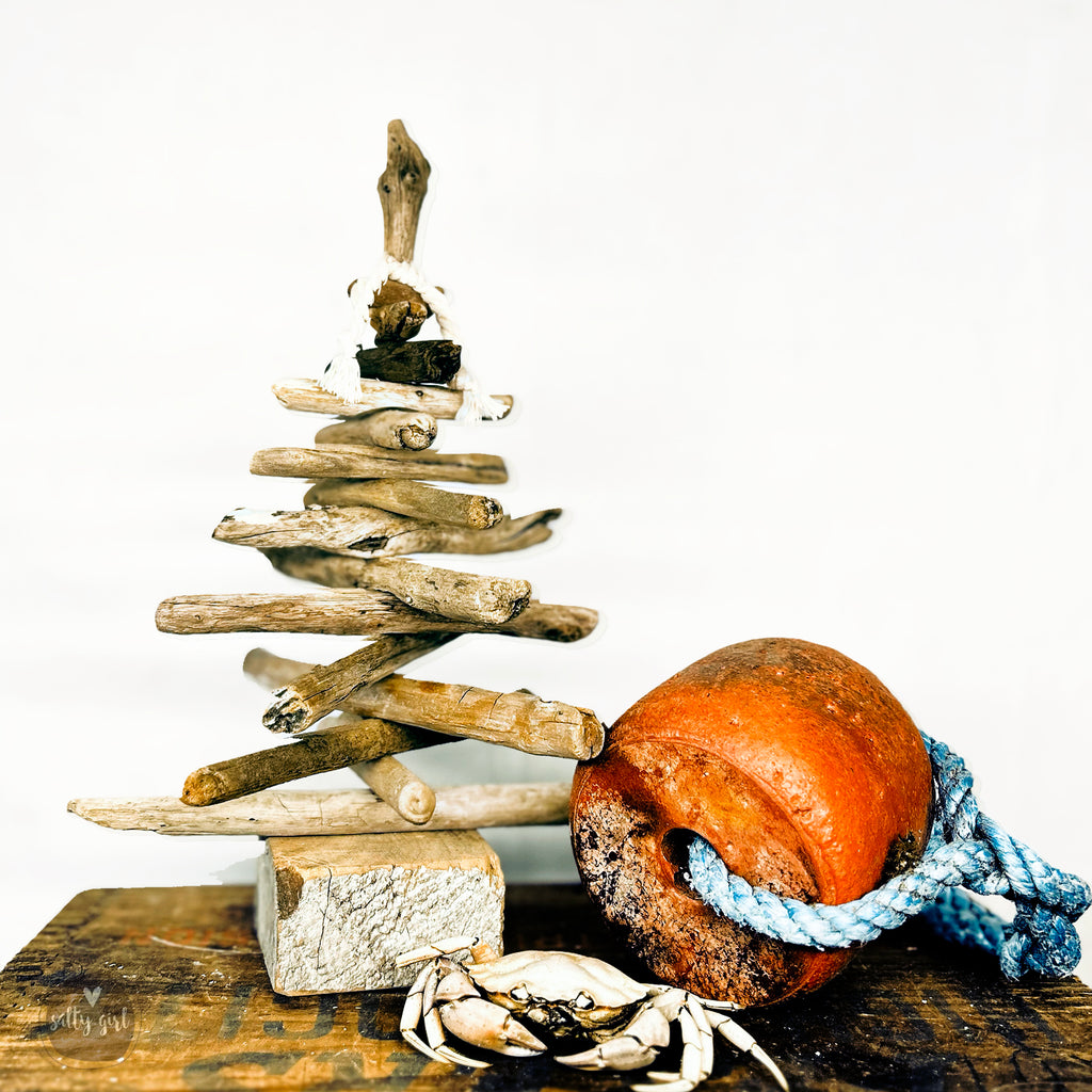mini driftwood Christmas tree next to crab and buoy