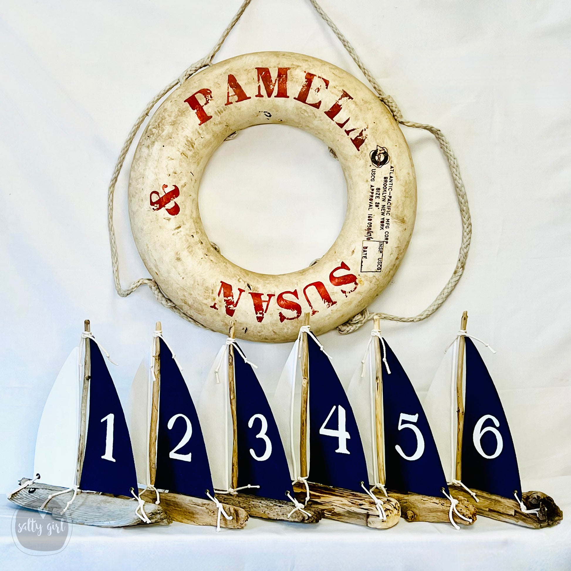 a row of sailboats sitting next to a life preserver