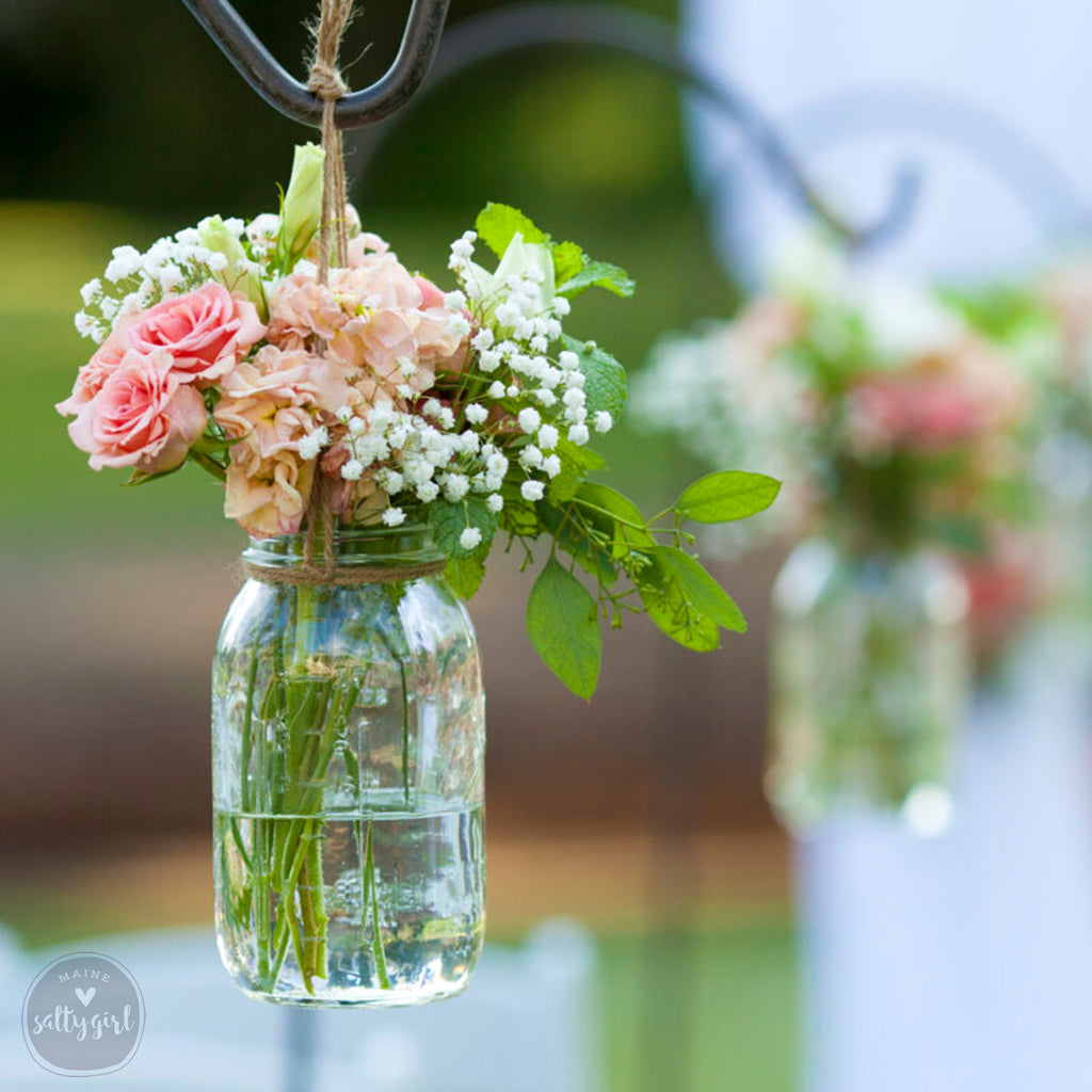 a couple of vases filled with flowers on top of a table