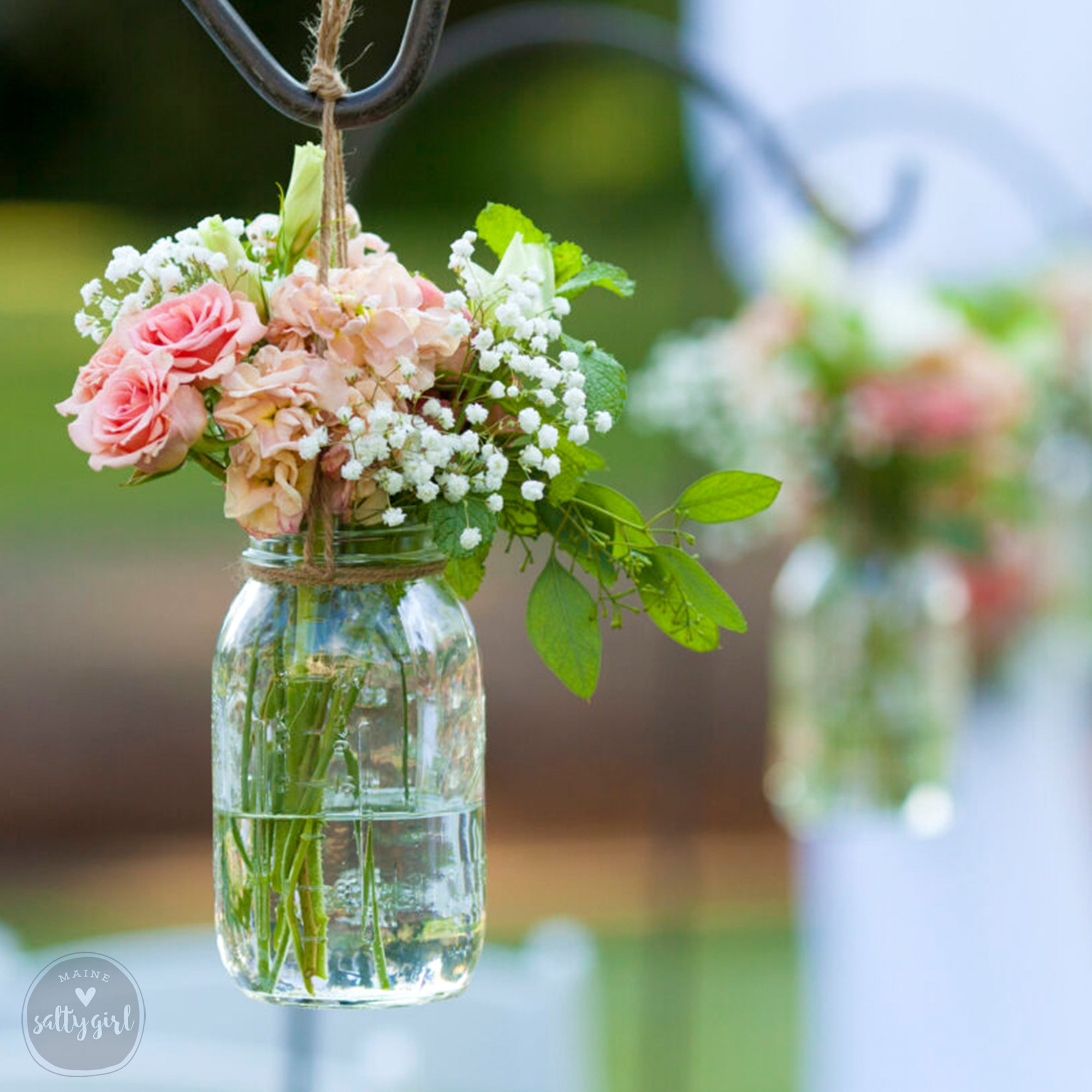 a couple of vases filled with flowers on top of a table