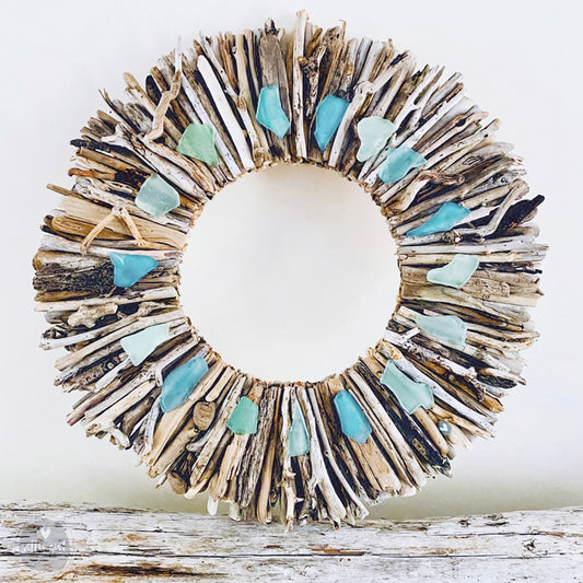 a wreath made out of driftwood and sea glass