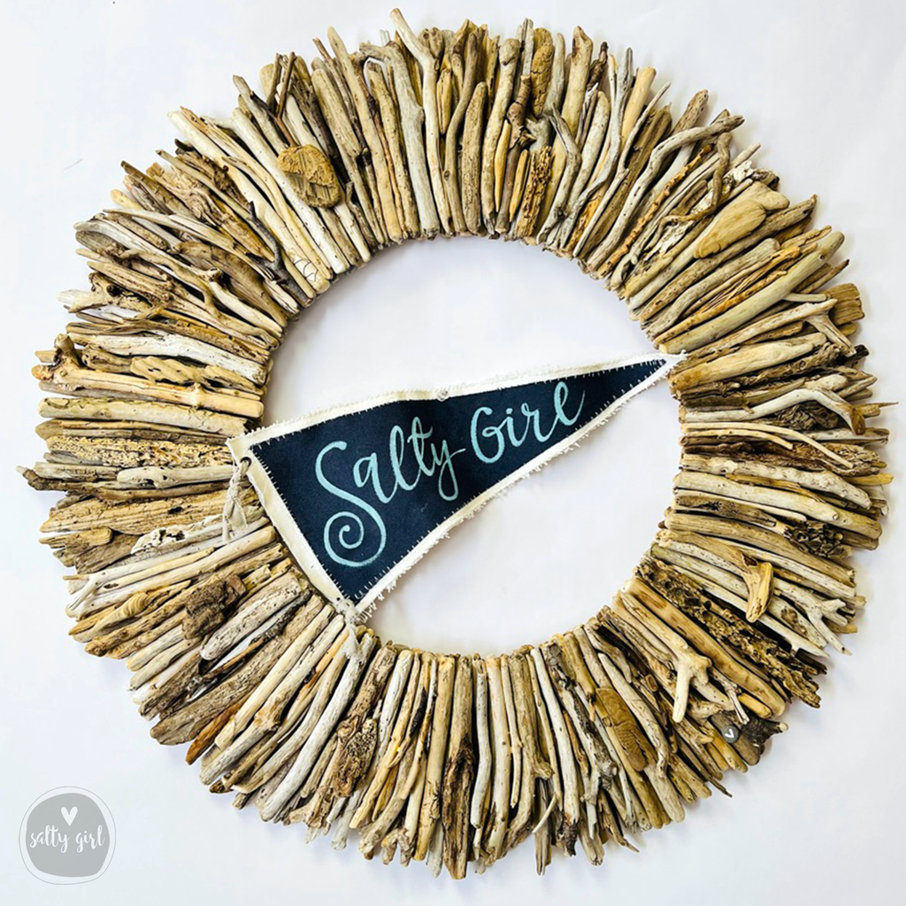 driftwood wreath with blue and white "Salty Girl" flag 