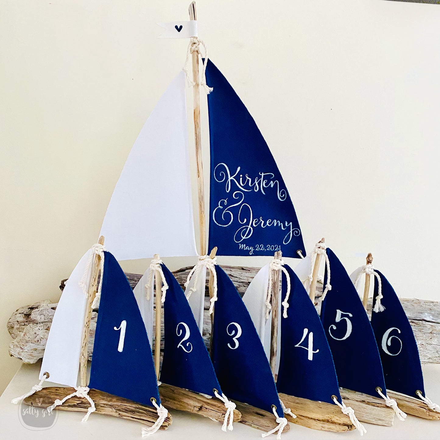 a row of sailboats with numbers on them