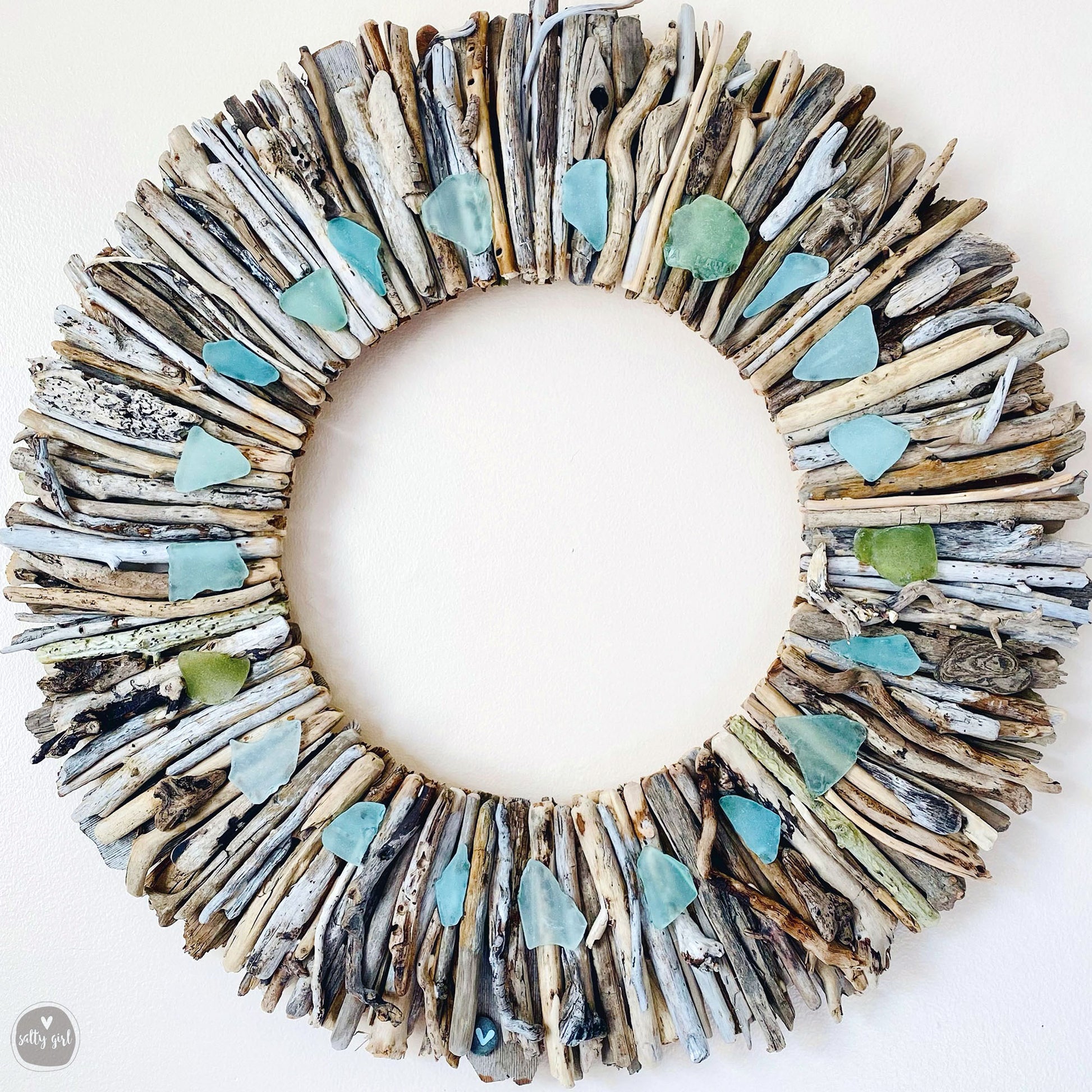 a wreath made out of driftwood and sea glass