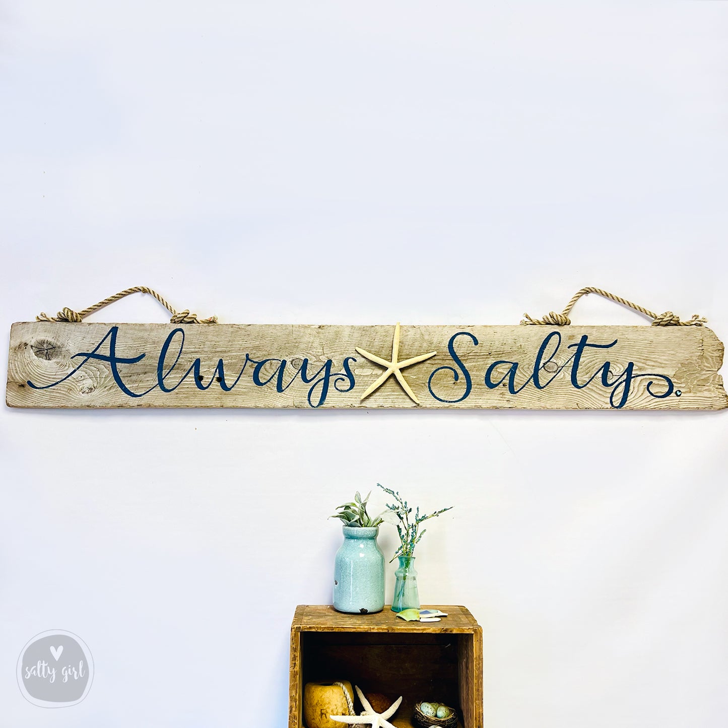a wooden sign that says always salty on it