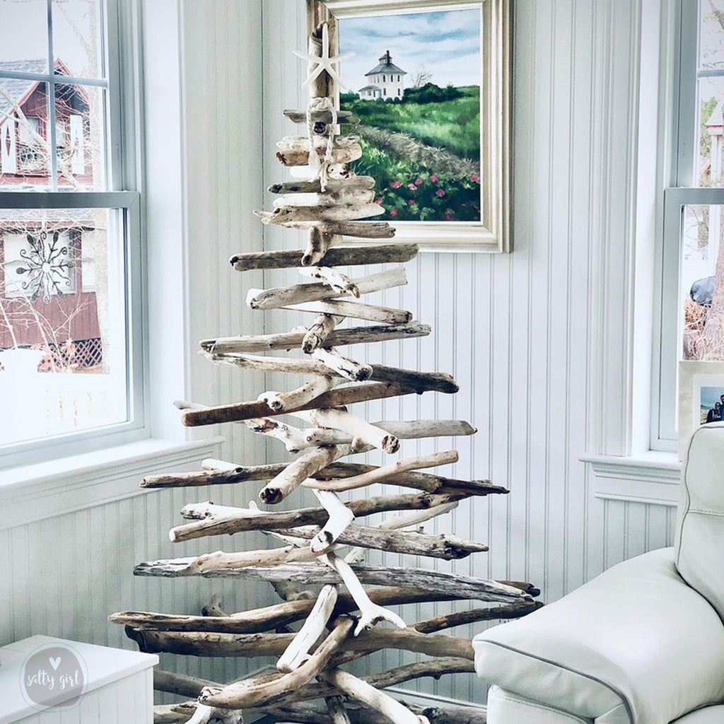 driftwood christmas tree in corner of a home with windows and a painting