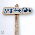 A wooden sign with the text "Salty Dog's Patch" written on it.