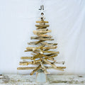 a wooden christmas tree made out of driftwood with starfish tree topper