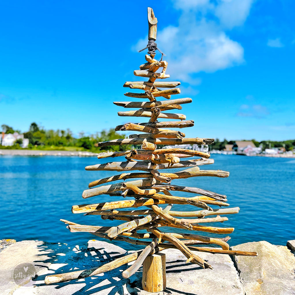 driftwood Christmas tree next to water