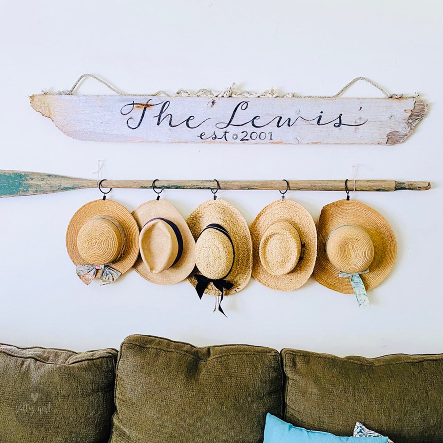 a wall mounted hat rack with hats hanging on it