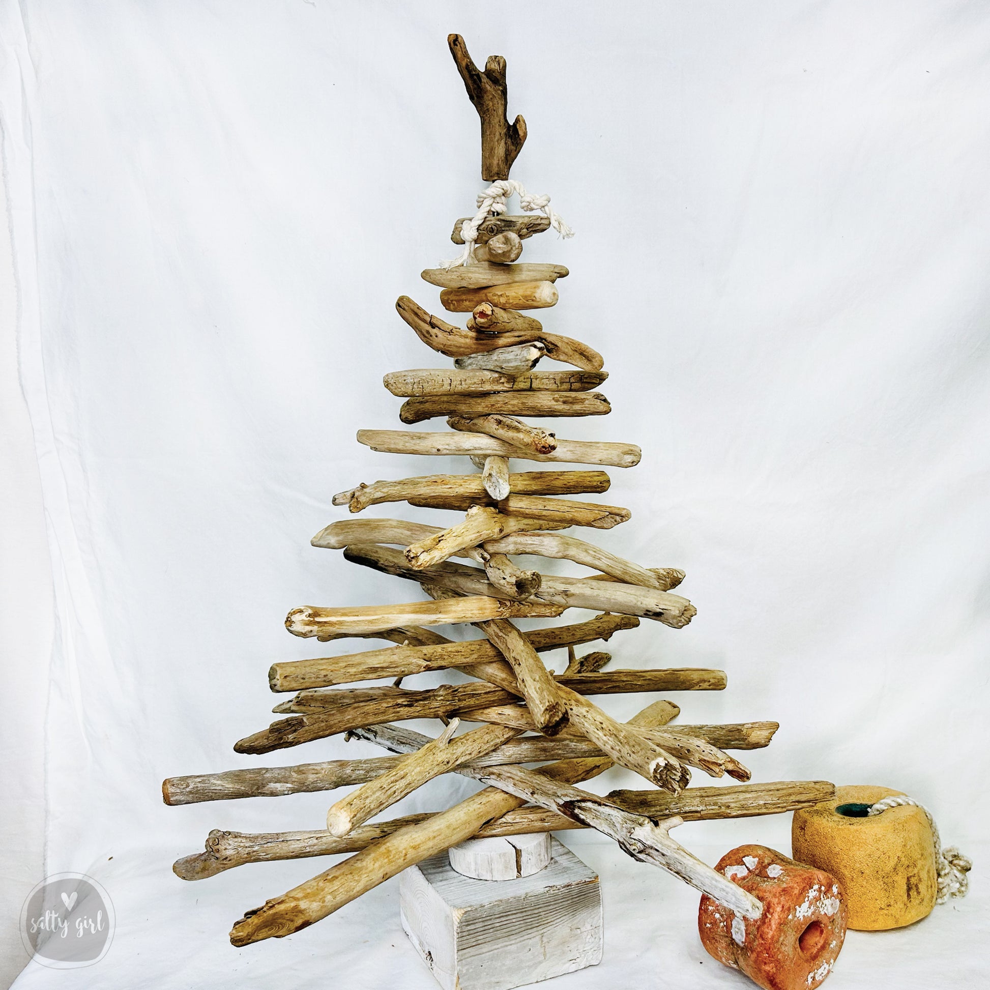 a wooden christmas tree made out of driftwood
